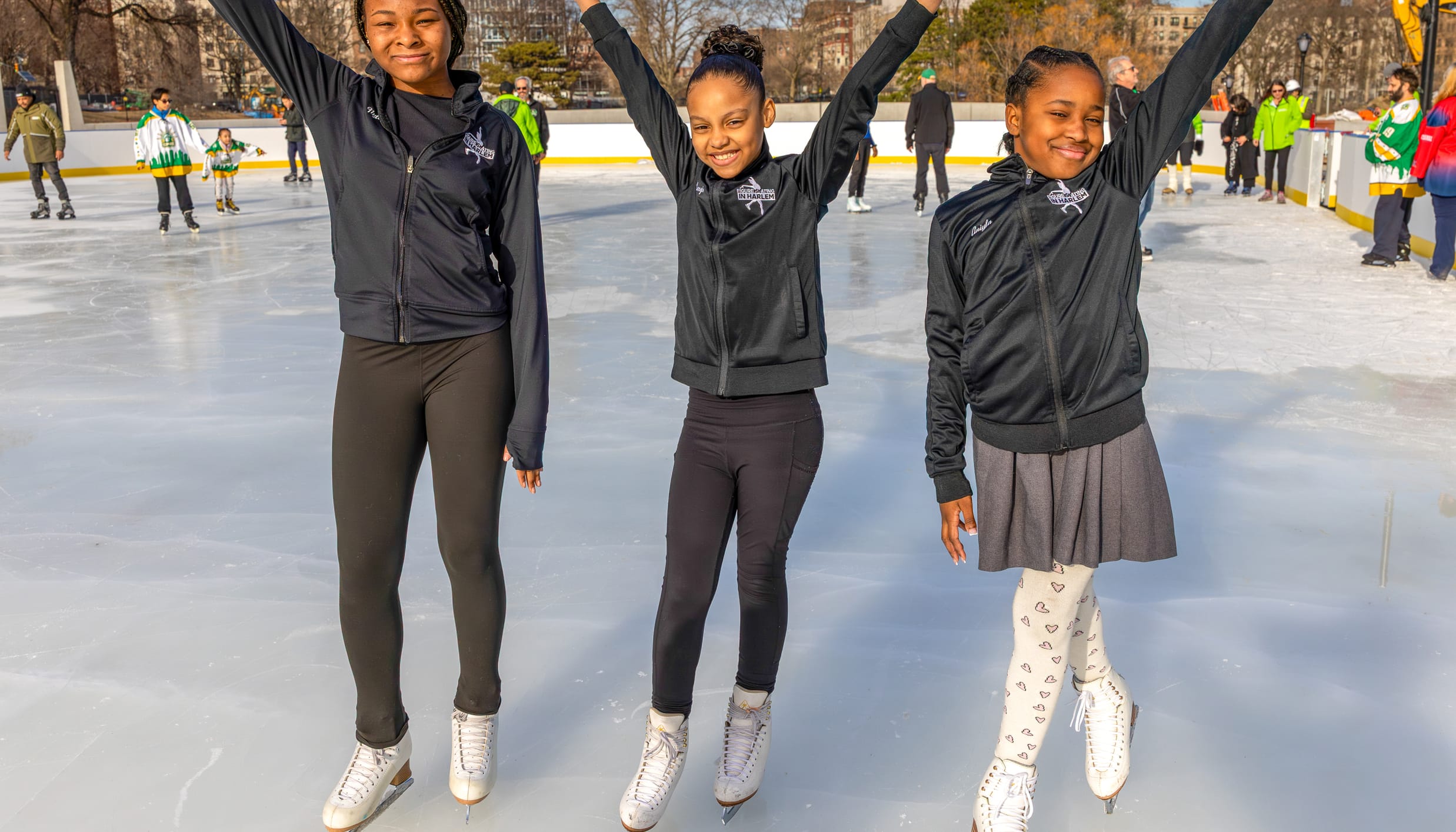 Three young people Figure Skating in Harlem at the Davis Center in Harlem, NYC