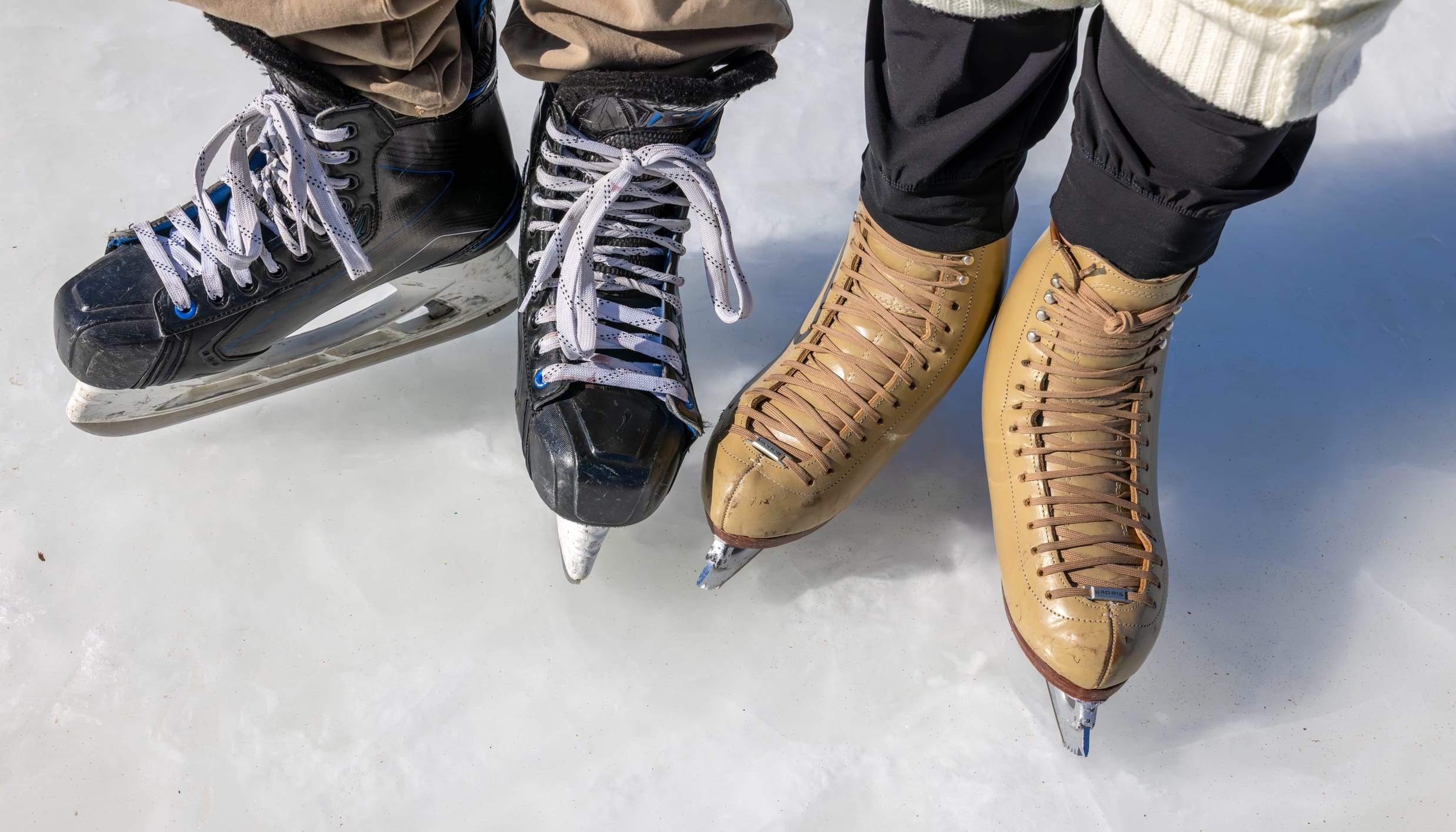 Closeup shot of two people wearing ice skates