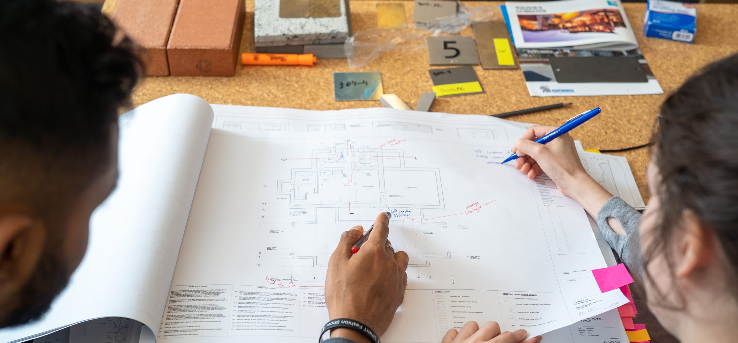Conservancy designers review an elevation and make notes