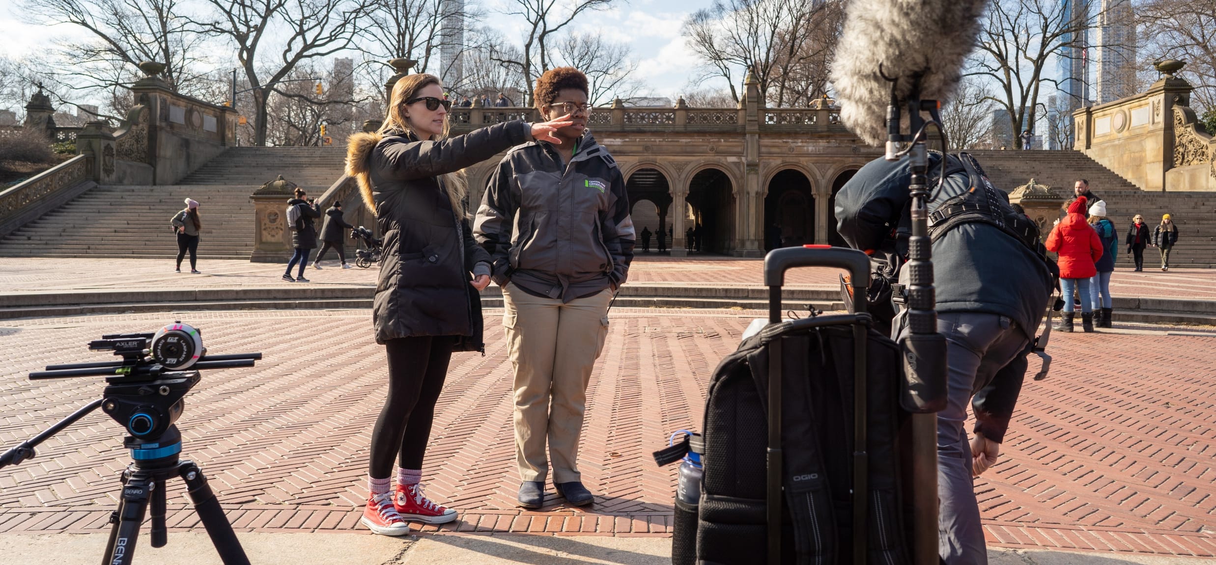 Two women map out a film shoot on Bethesda Terrace in winter